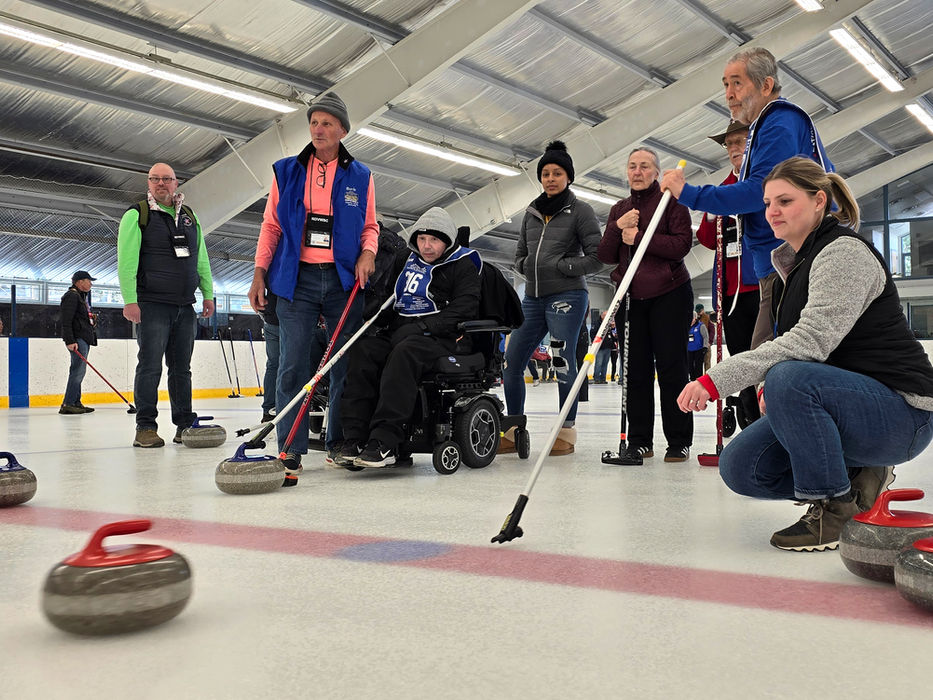 Signature Performance team participating in an adaptive curling event
