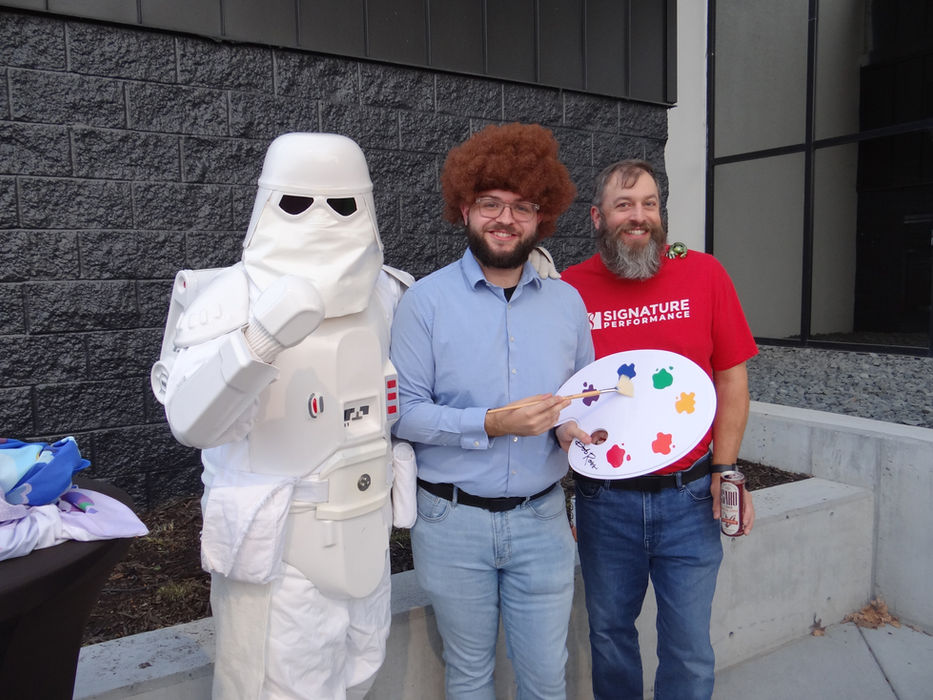 Signature Performance team members in costume at a company event