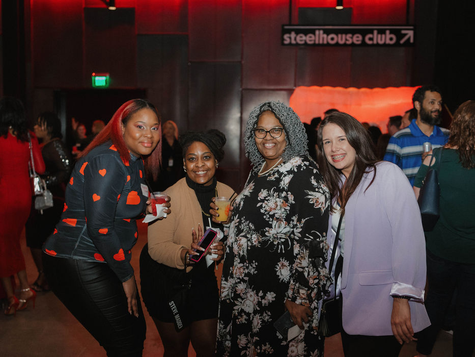 Signature Performance team members socializing at a company evening event
